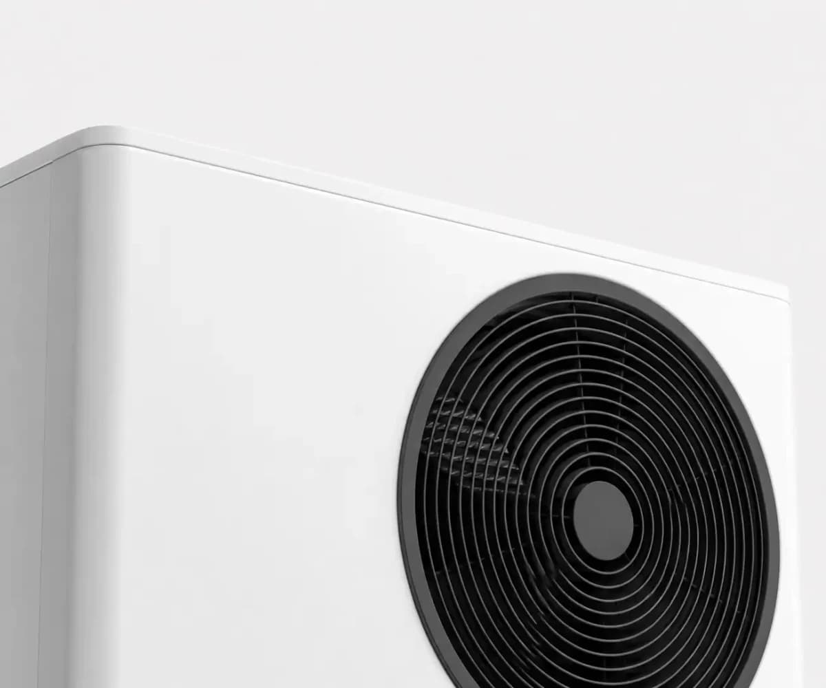 An air source heat pump on a brick wall